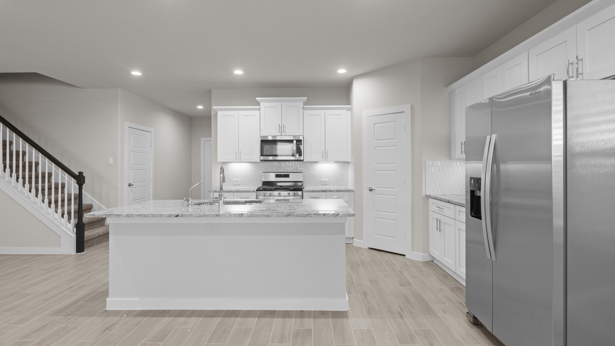 Open concept kitchen overlooking family and living room area