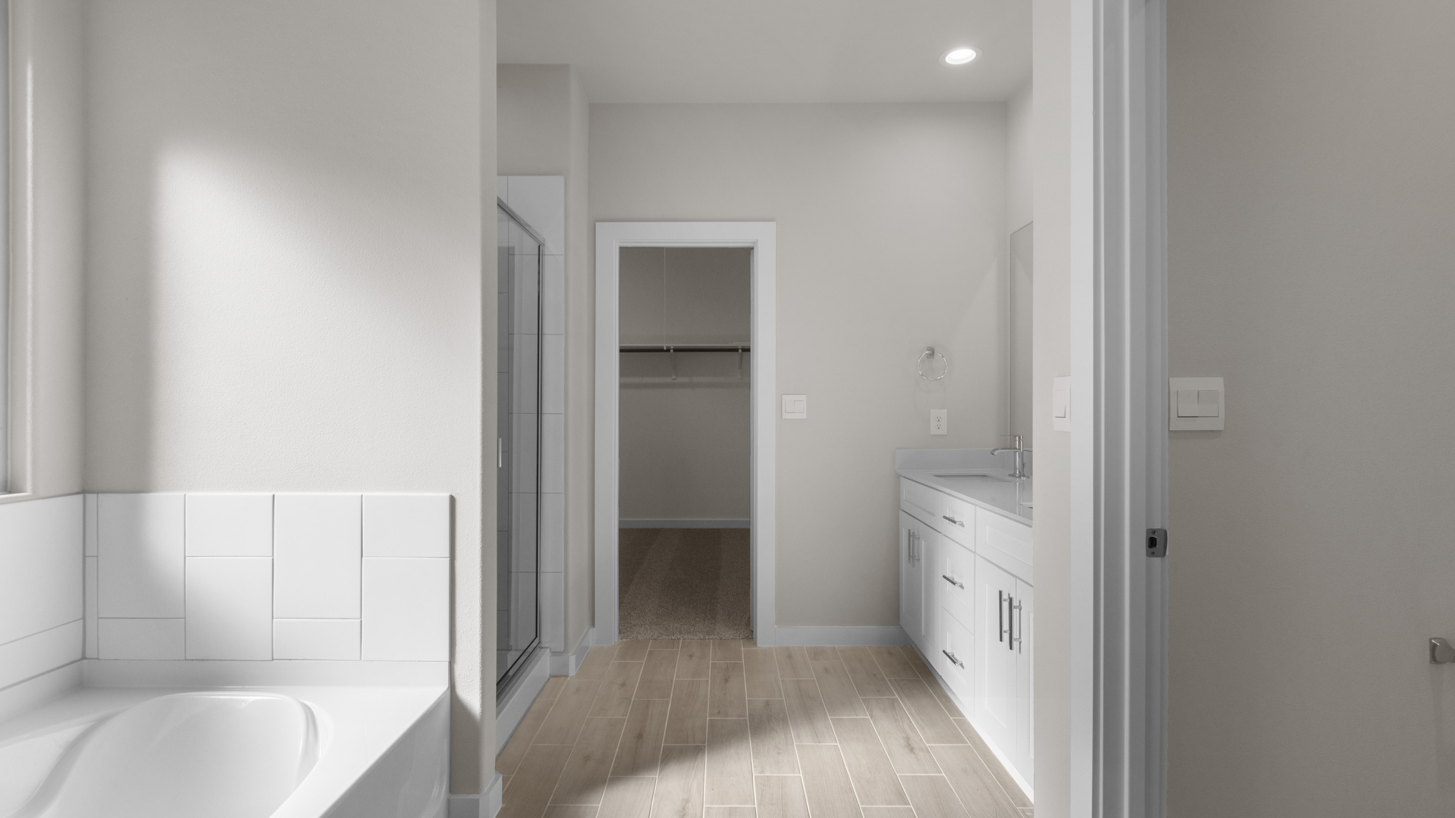 Primary bathroom with attached walk in closet and separate water closet