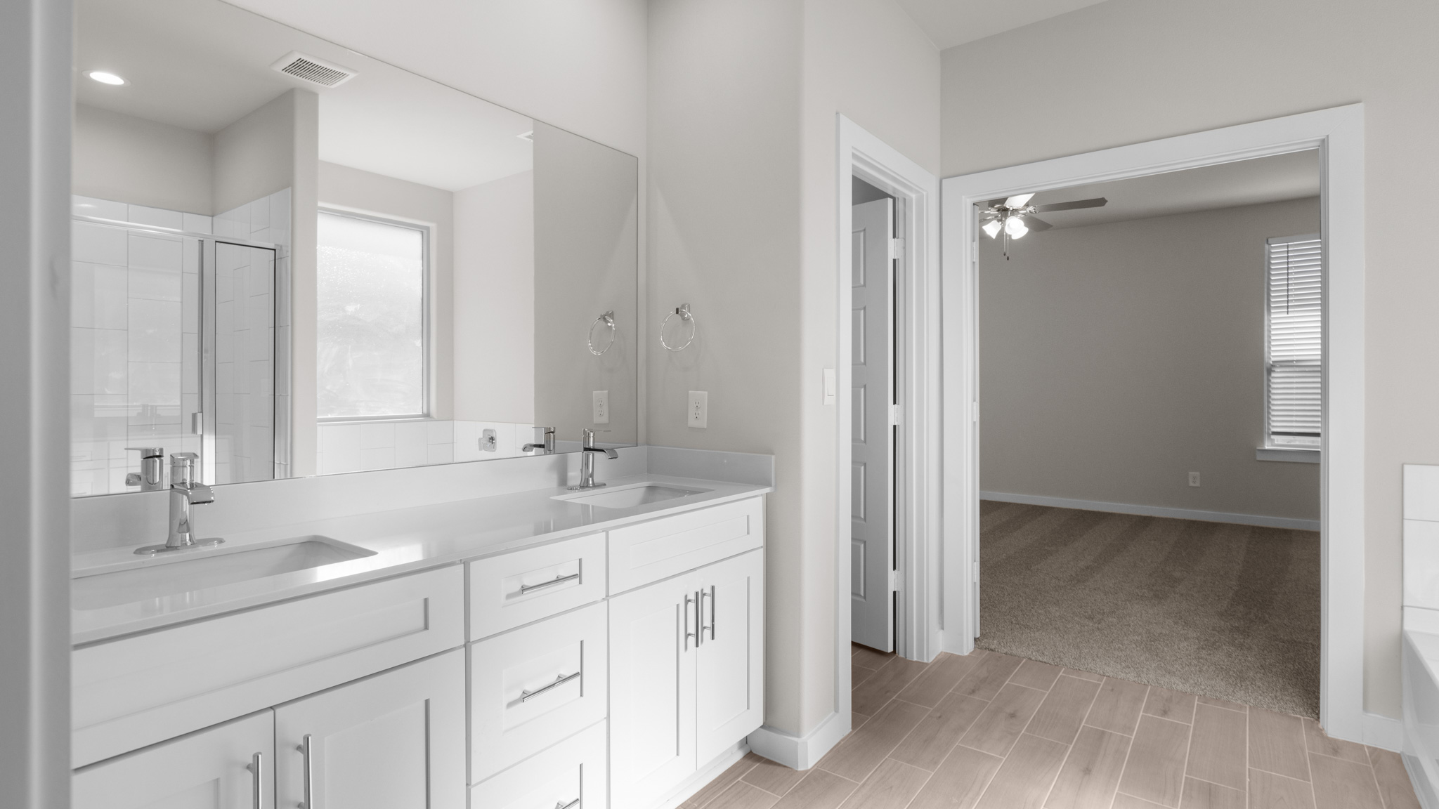 Primary bathroom with marble vanity tops and double sinks