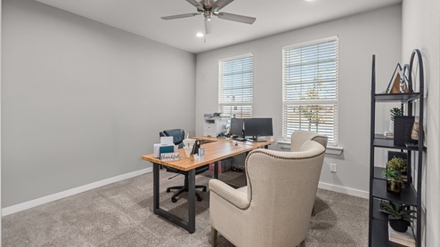 Guest bedroom used as a designated office space with front facing double windows and ample natural light