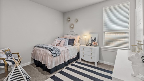 Guest bedroom 1 designed as a little girls room with timeless black, white, and rose pink colors