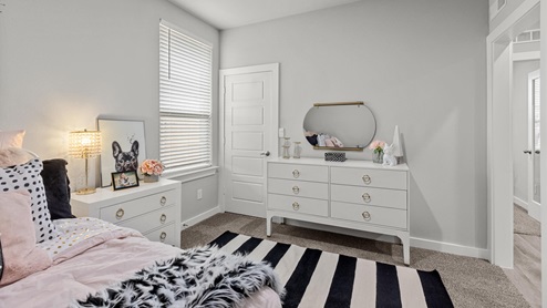 Guest bedroom decorated as a kids room with black and white colors and pops of pale pink and gold