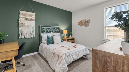 Guest bedroom 2 decorated as a modern teen girl's room with warm trendy pink and green boho colors