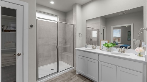 Private primary bathroom with walk in shower and spacious vanity