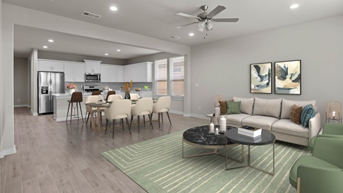 Open concept kitchen, living, and dining area space decorated with relaxing warm colors and a touch of sage green accents