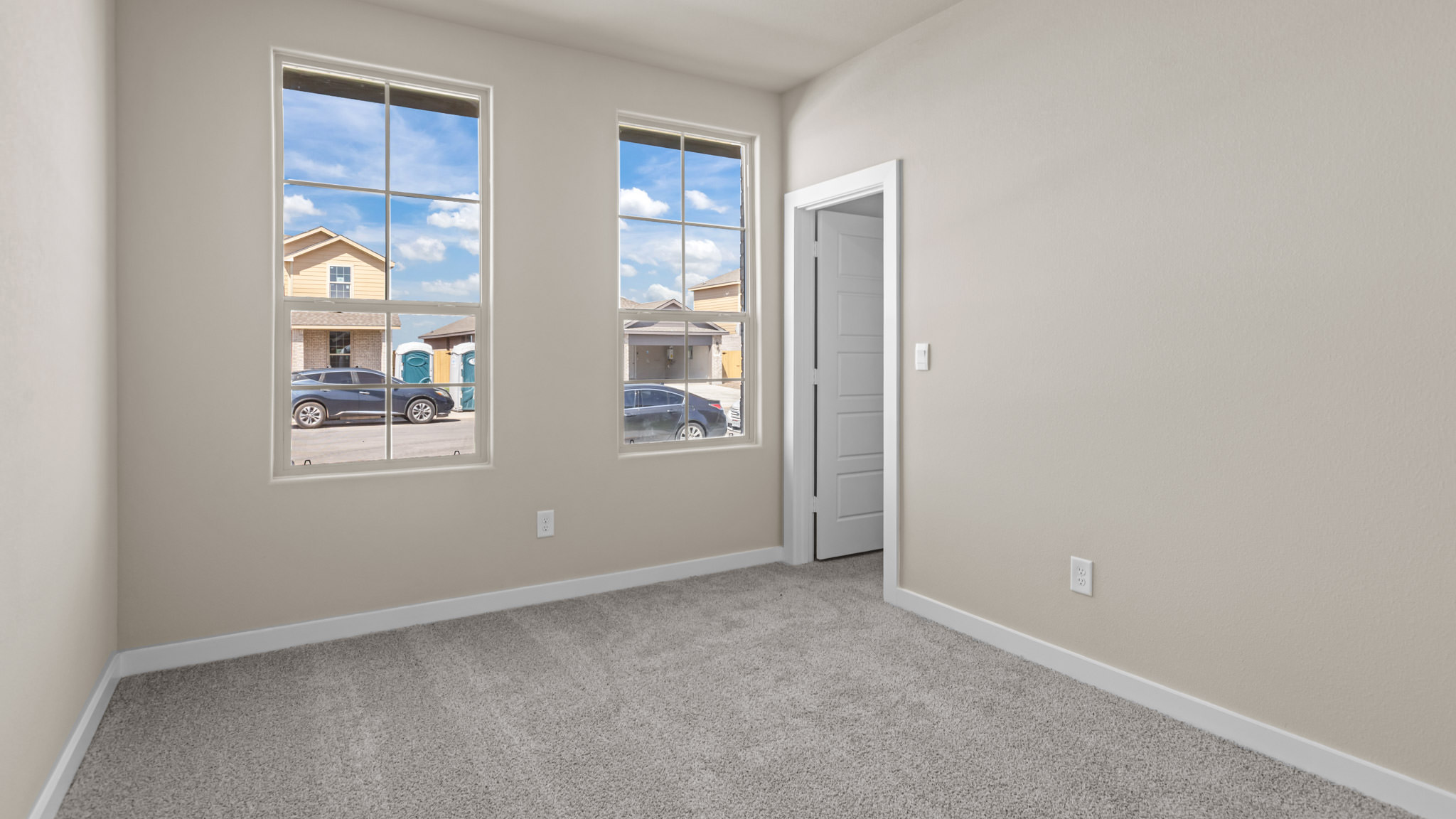 Guest bedroom 1 with front windows and ample natural light