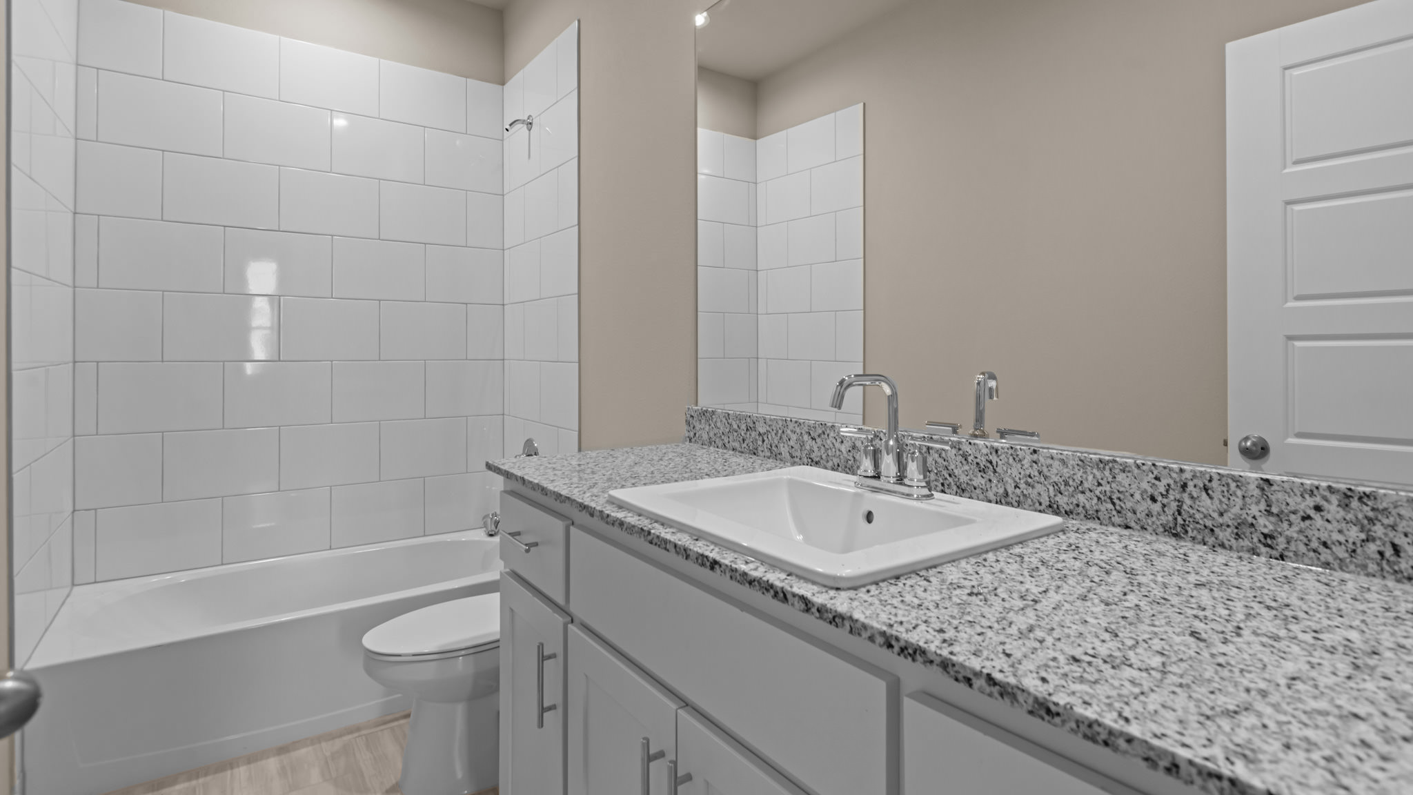 Guest bathroom with built in vanity and combination bathtub shower