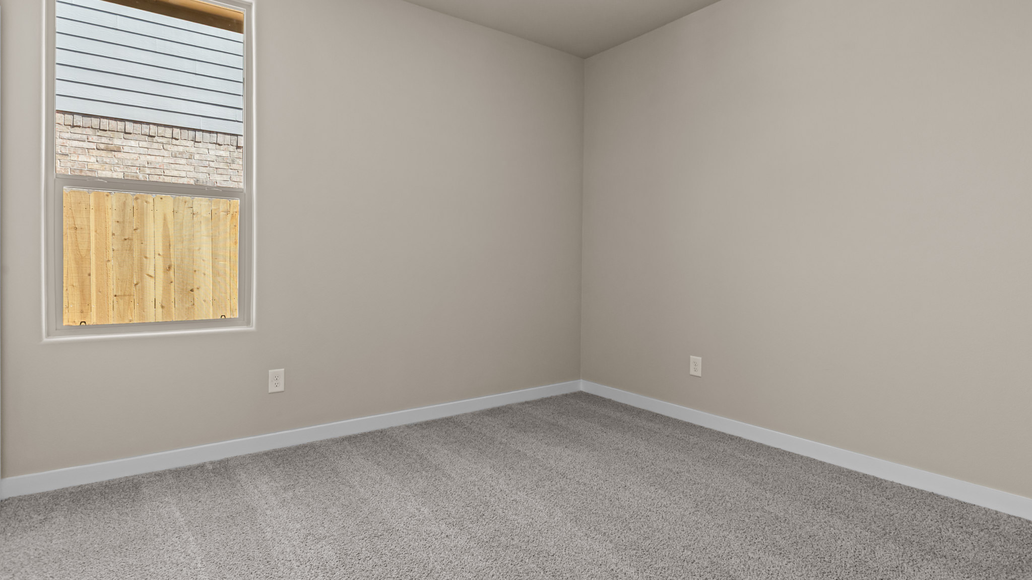 Guest bedroom 2 with side window and plush carpet floor