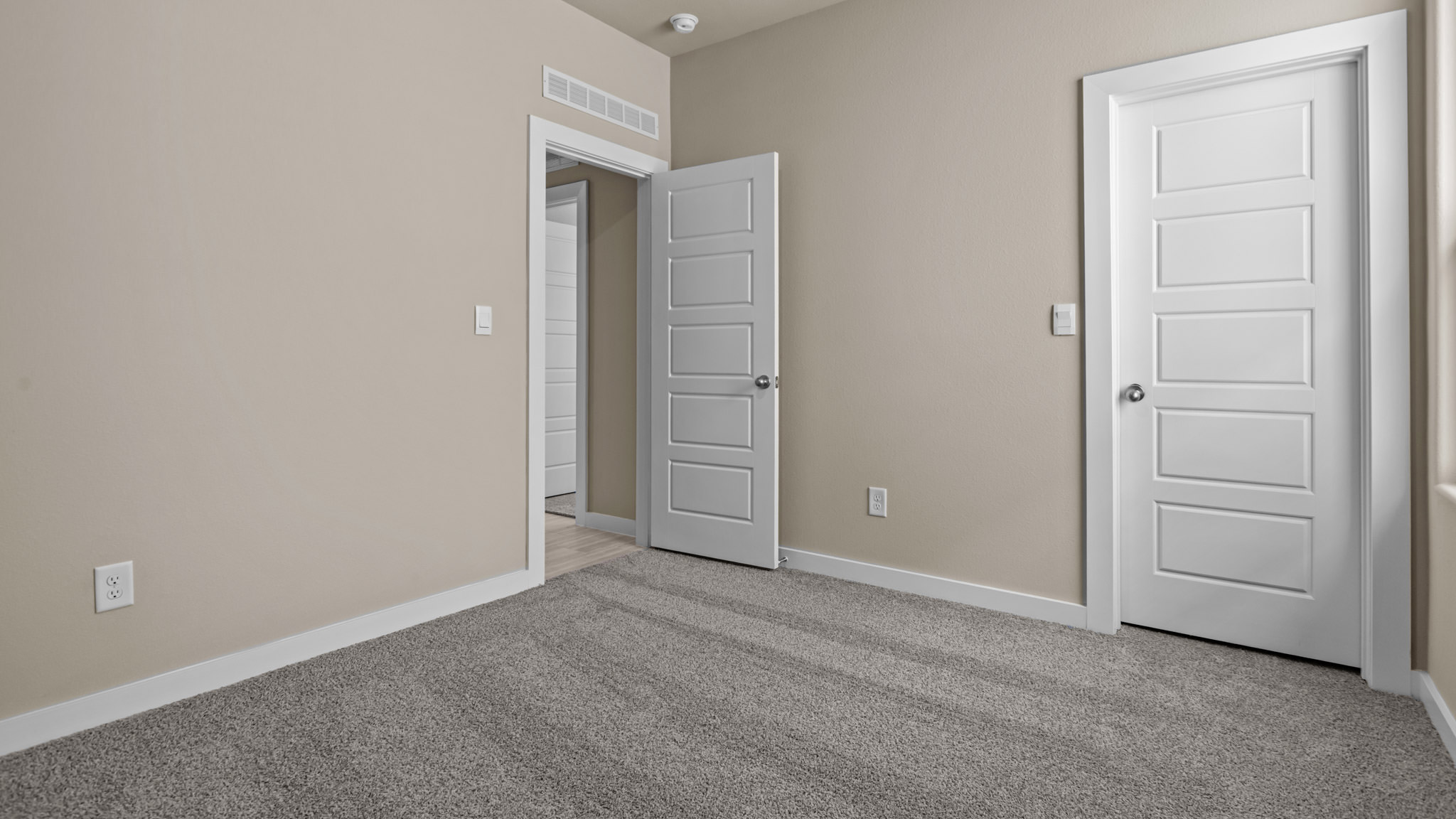 Guest bedroom 2 with side window and plush carpet floor