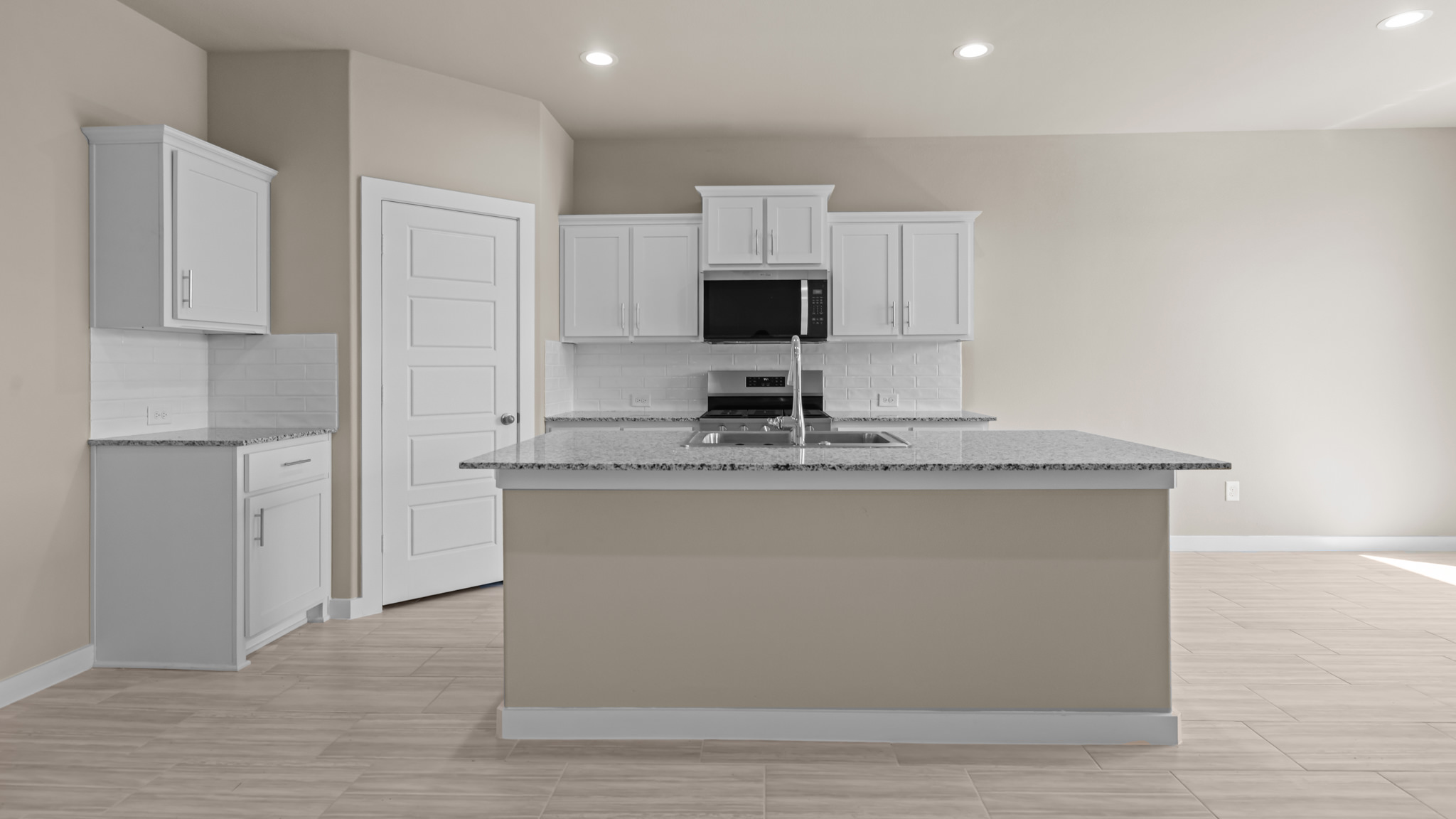 Spacious open concept kitchen with island and counter prep space