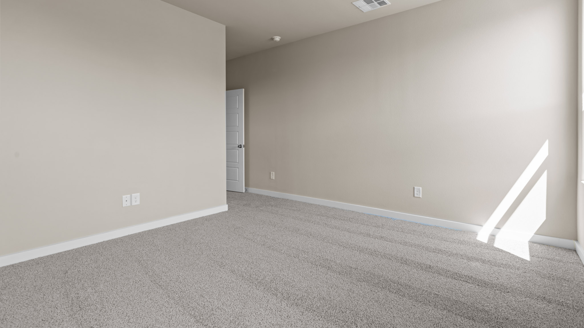 Primary bedroom with private attached bathroom and walk-in closet