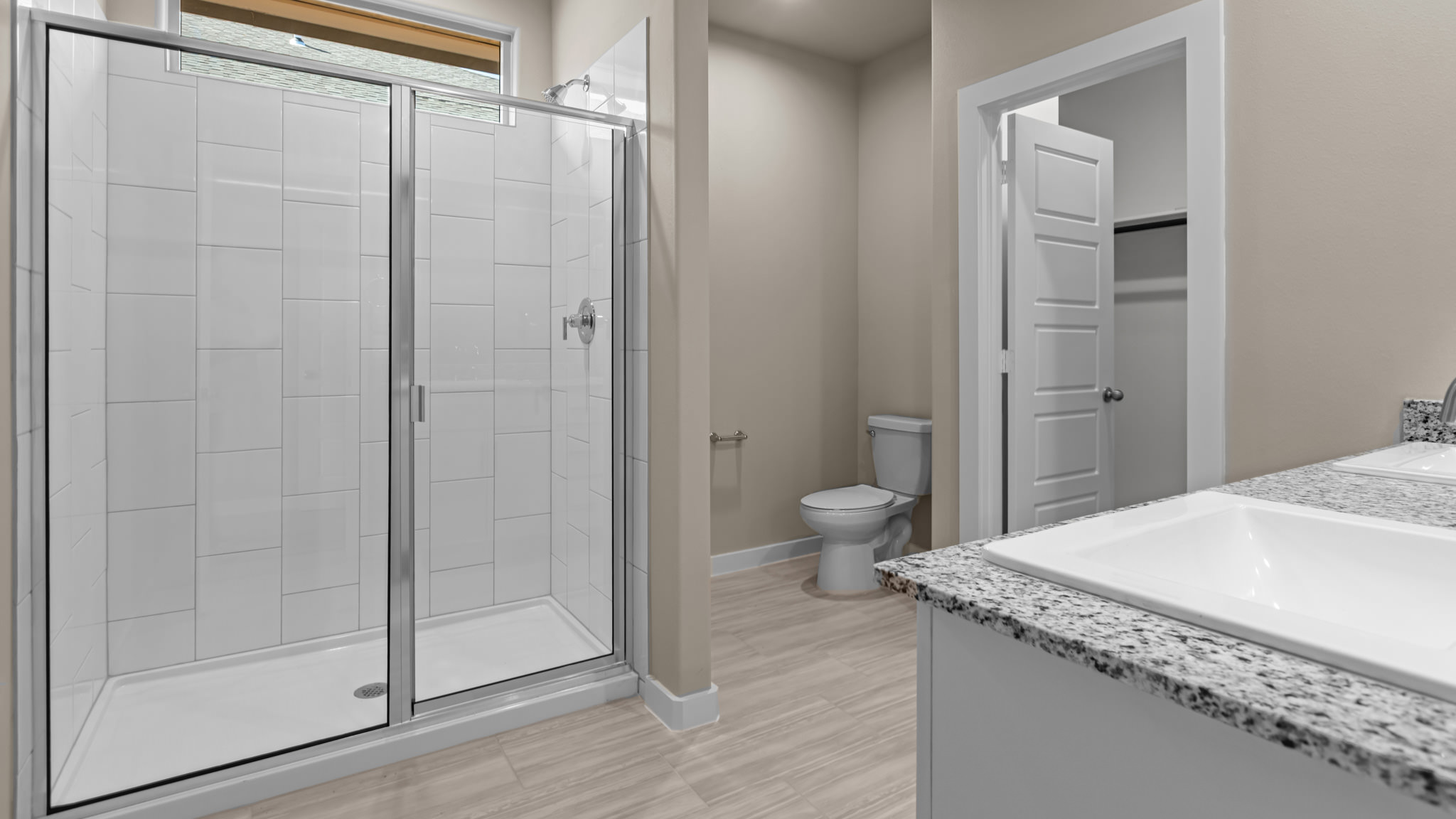 Primary bathroom with private water closet and walk-in closet