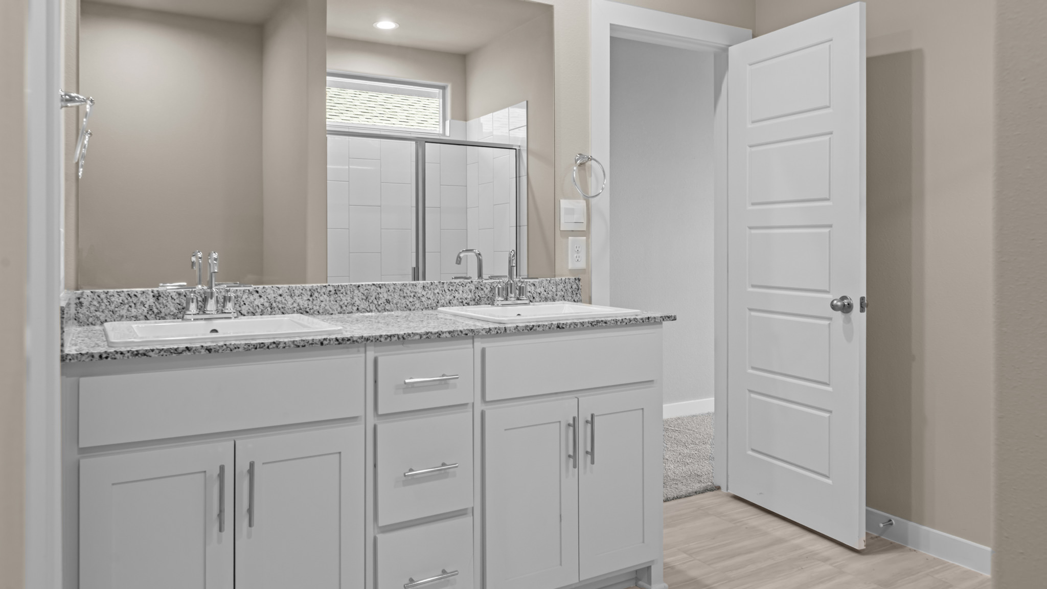 Primary bathroom with built in vanity and luxurious shower