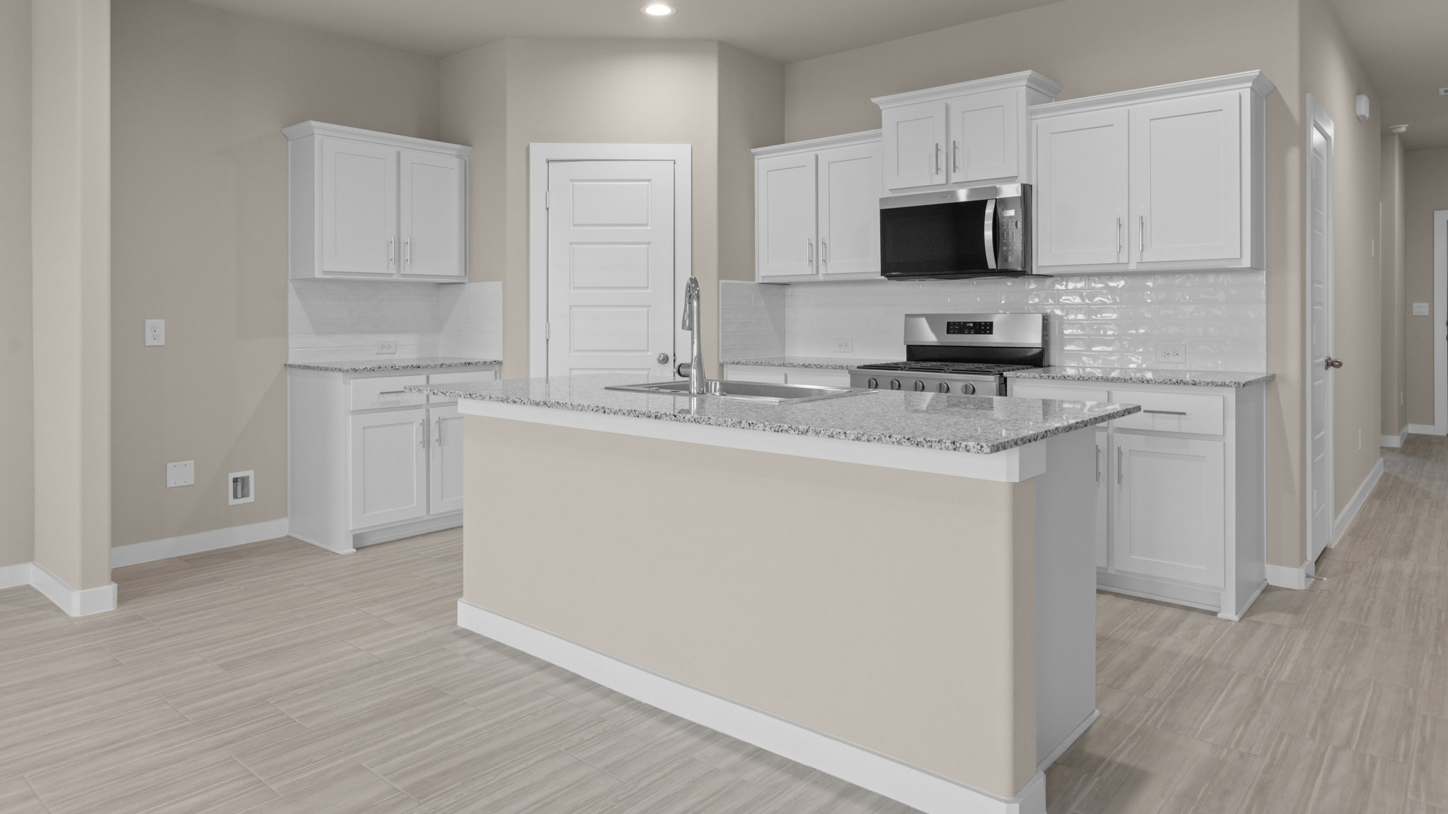 Open concept kitchen with stainless steel appliances, shaker style cabinets, and elevated finishes