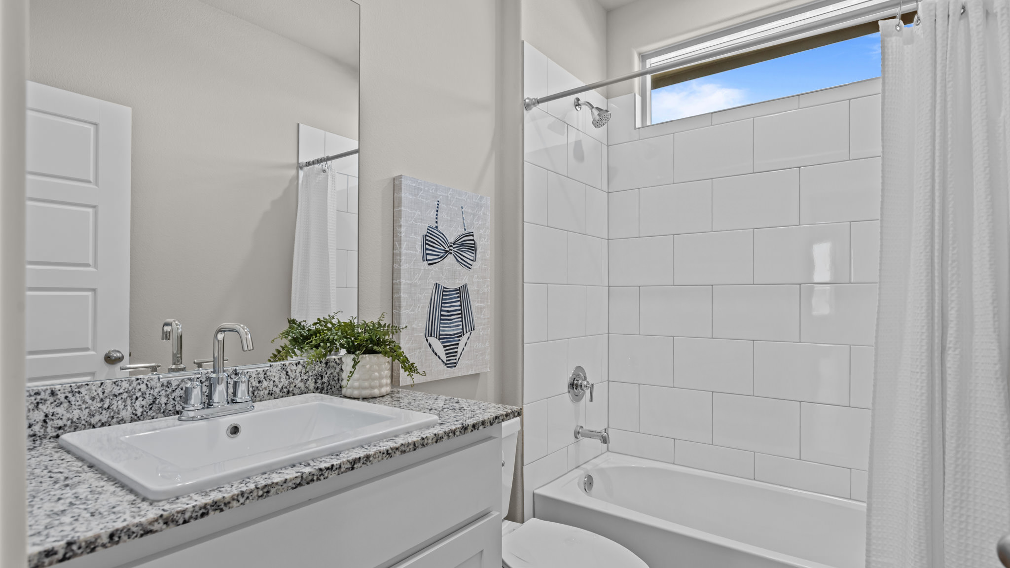 Guest bathroom located between guest bedrooms