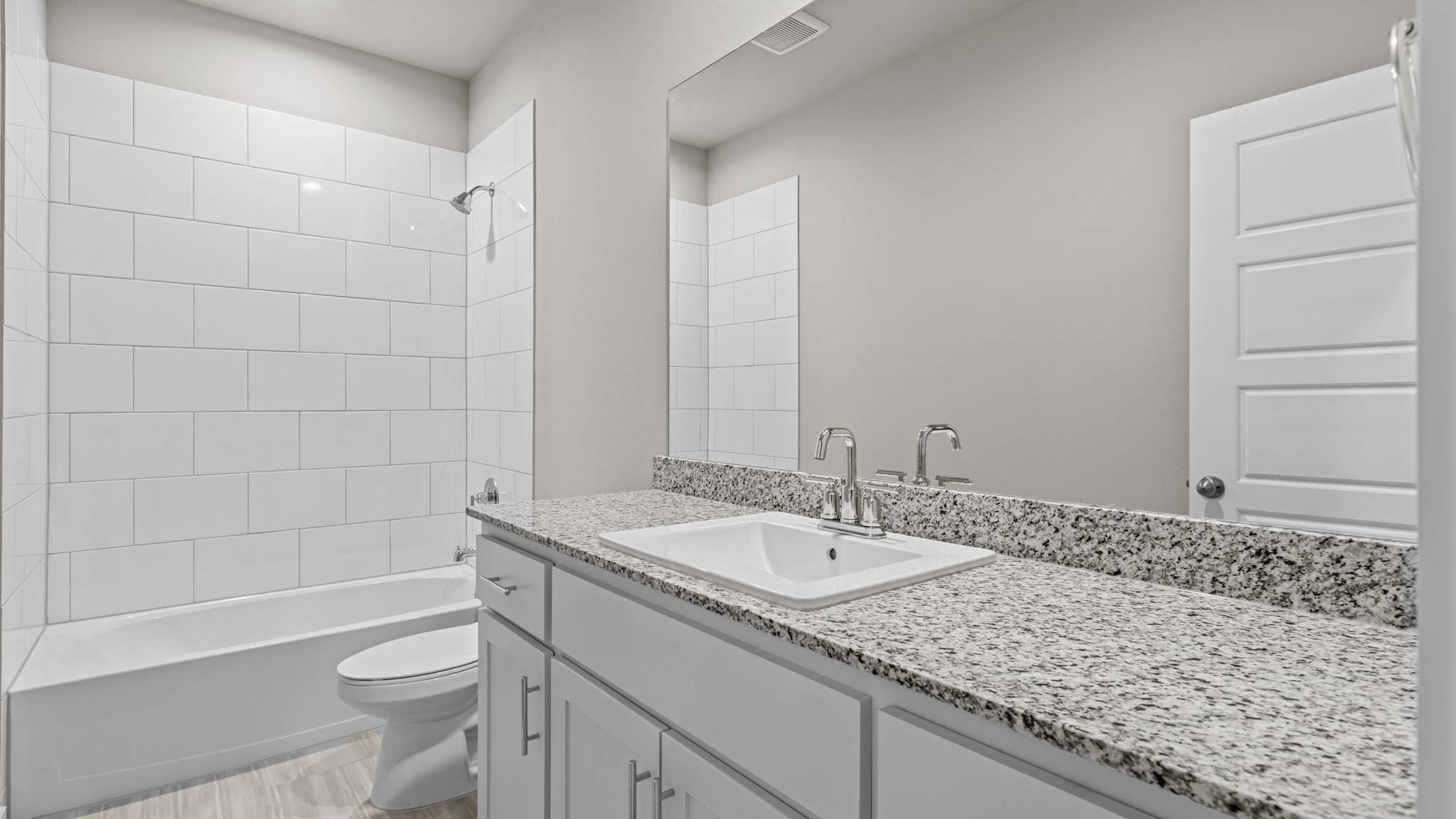 Guest bathroom with built in vanity and combination bathtub shower