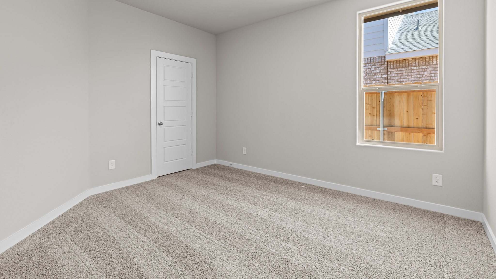 Guest bedroom 4 with plush carpet and side window