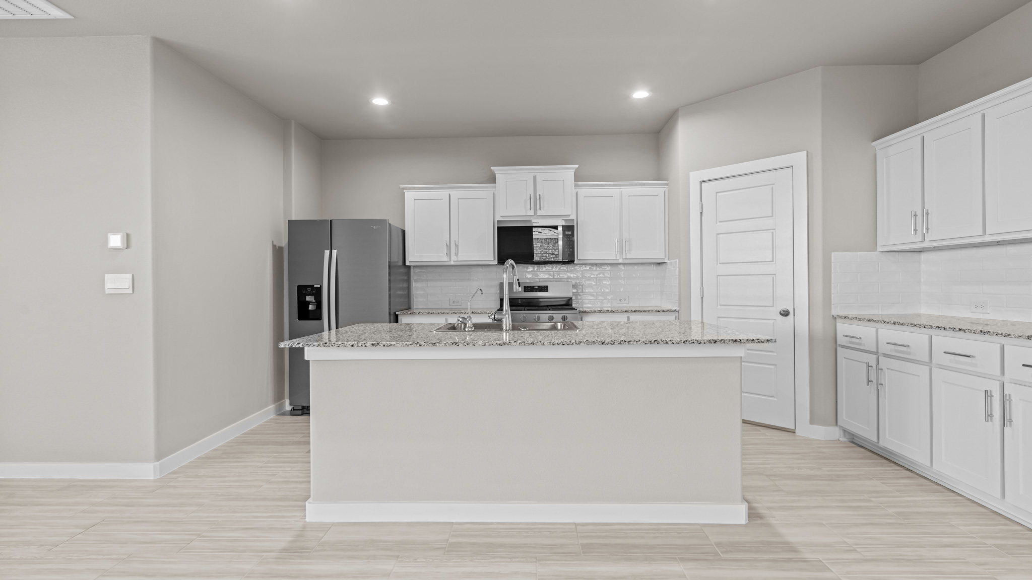 Spacious open concept kitchen with island and counter prep space