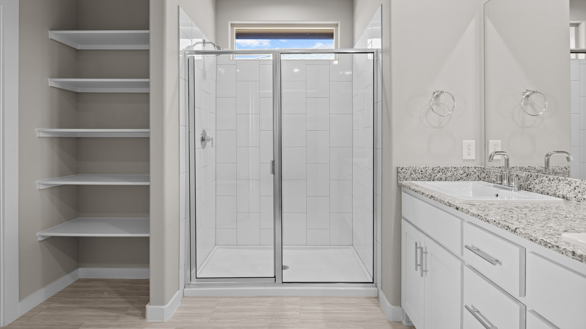Primary bathroom with luxurious shower and built in storage