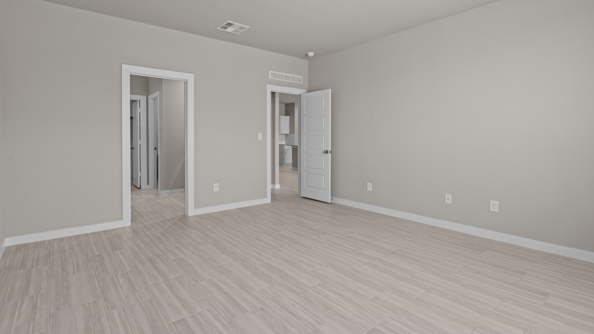 Primary bedroom with private attached bathroom and walk-in closet