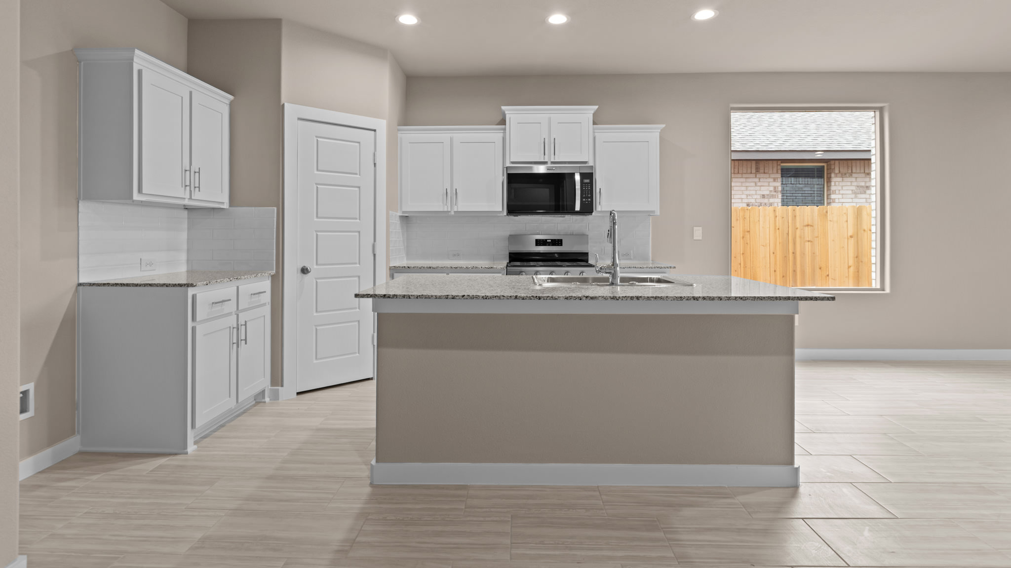 Spacious open concept kitchen with island and counter prep space