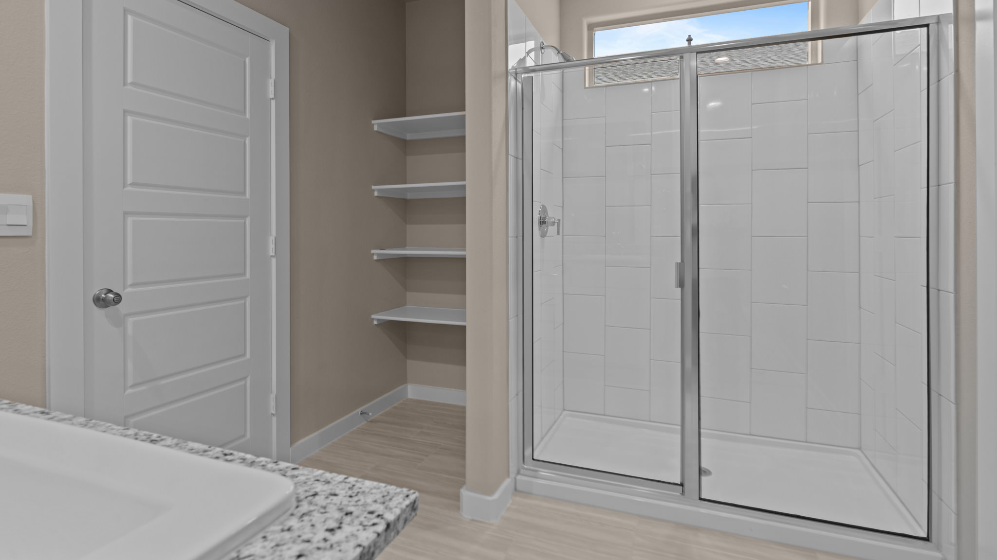 Primary bathroom with luxurious shower and built in storage