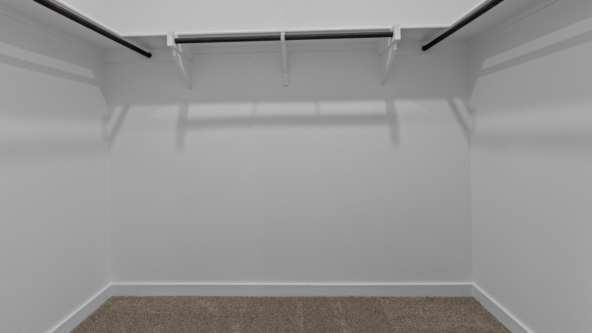 Private primary walk-in closet with extra storage space