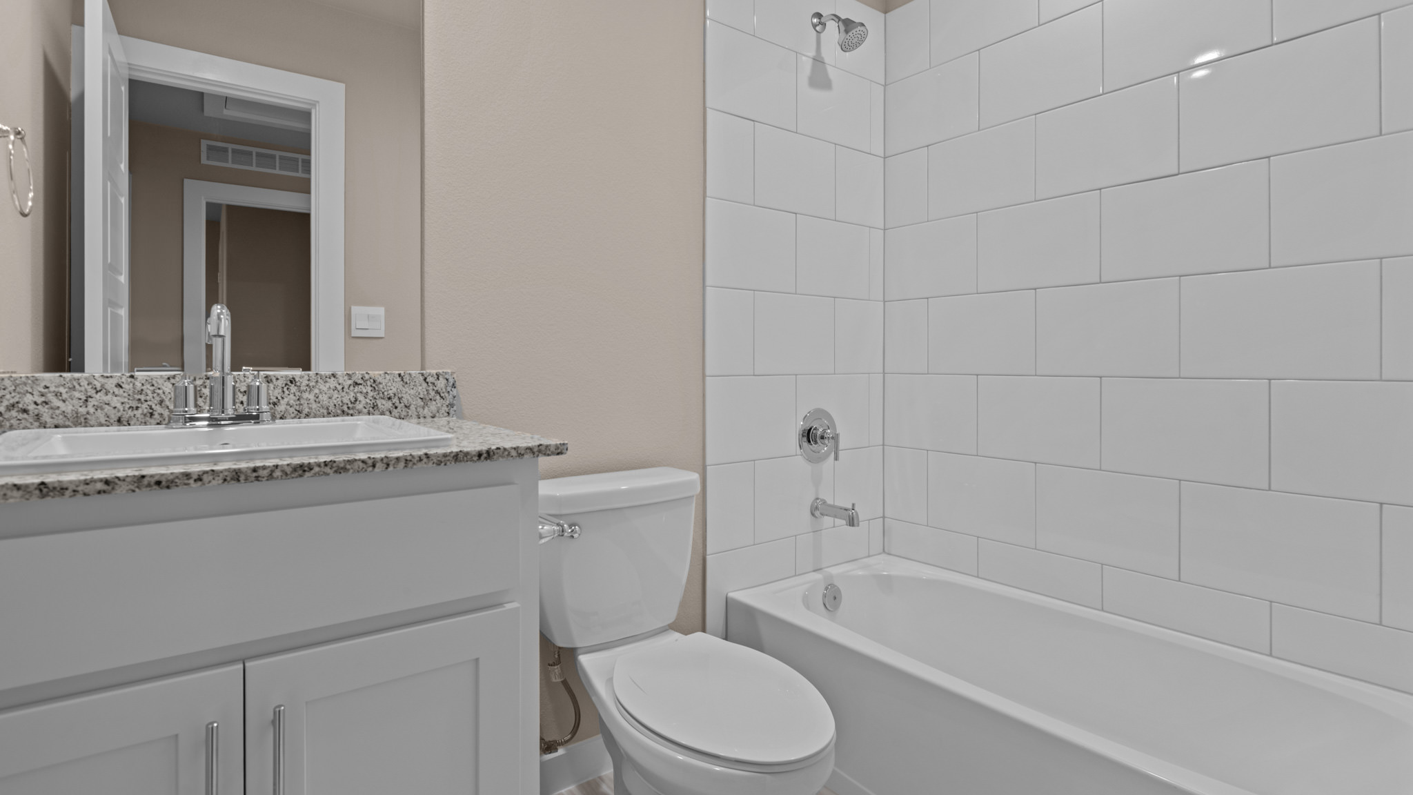 Upstairs guest bathroom with combination shower and bathtub