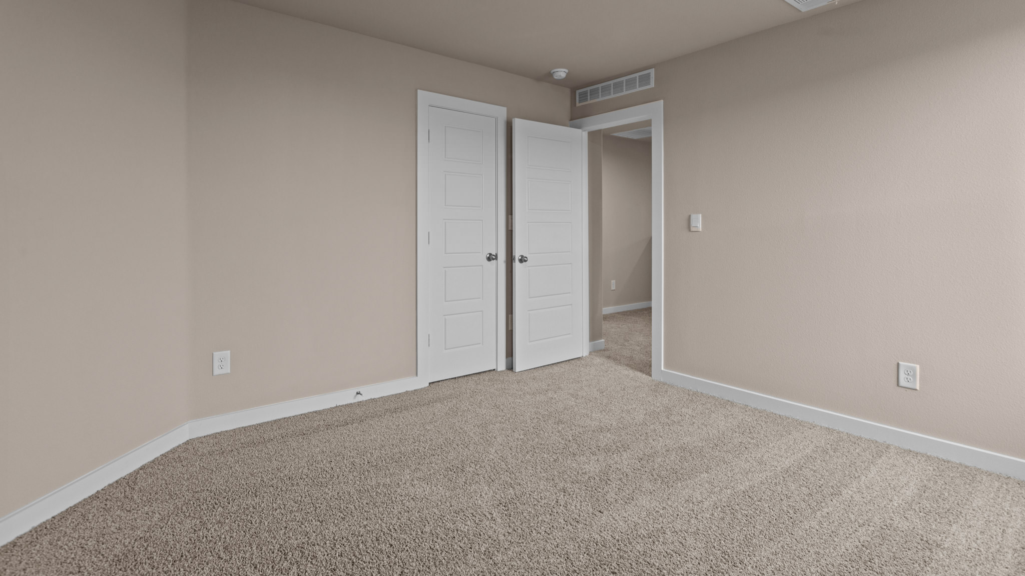 Upstairs guest bedroom 3 with plush carpeted floors and ample natural light