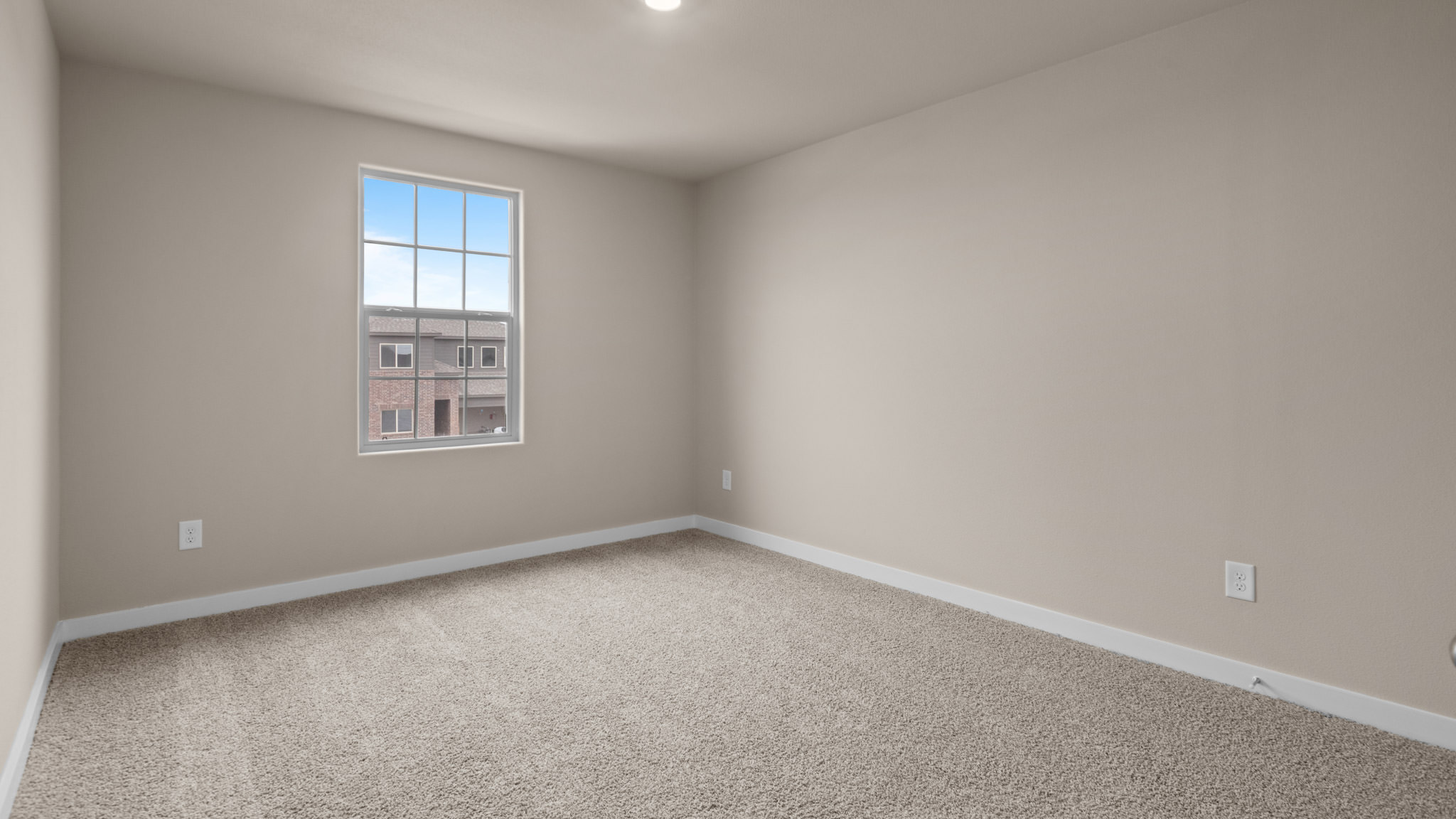 Upstairs guest bedroom 4 with plush carpet floors and side window