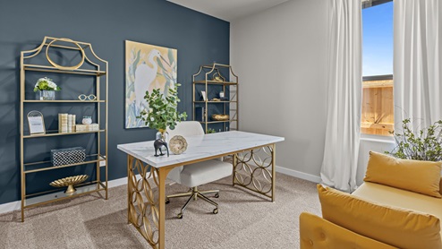 Guest bedroom 1 decorated as an office with gold and blue accents