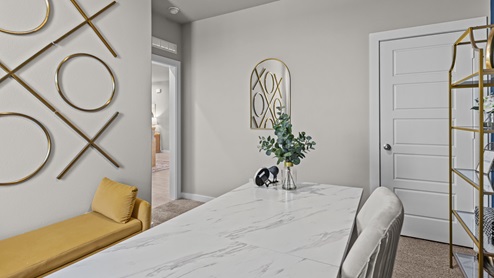 Guest bedroom used as an office with gold accents and clean modern finishes