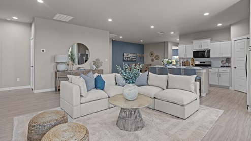Spacious open concept living, kitchen, and dining room space with modern coastal decor and central home location