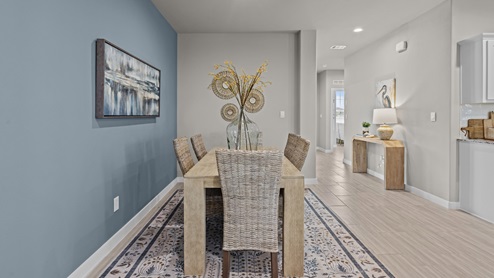 Designated dining space off side of hallway and kitchen decorated with modern coastal flair