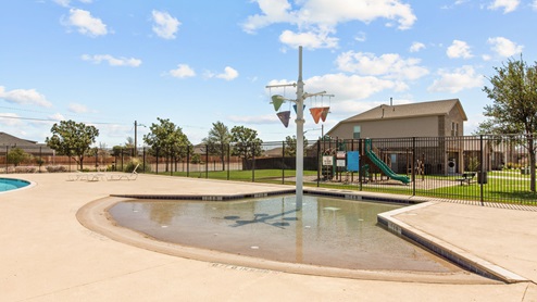 Splash pad area for kids located in fenced in community pool area