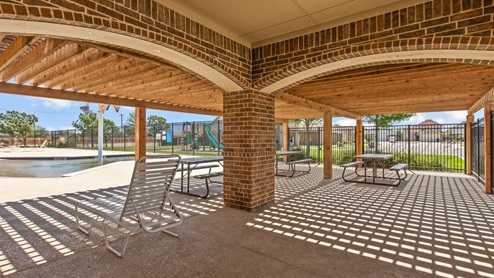 Community amenities center with covered pool seating area