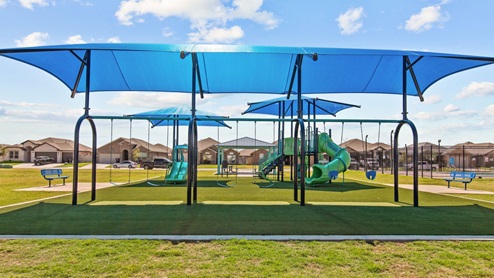 Covered play area with swings and soft turf play flooring