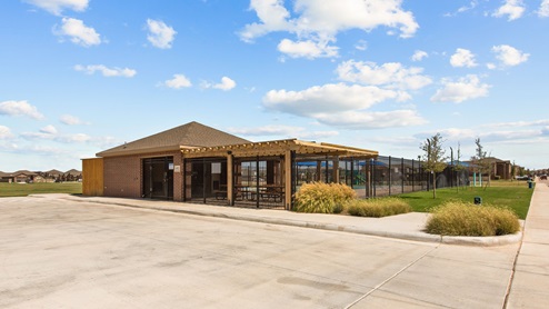 Community amenities center with covered pool deck and landscaping