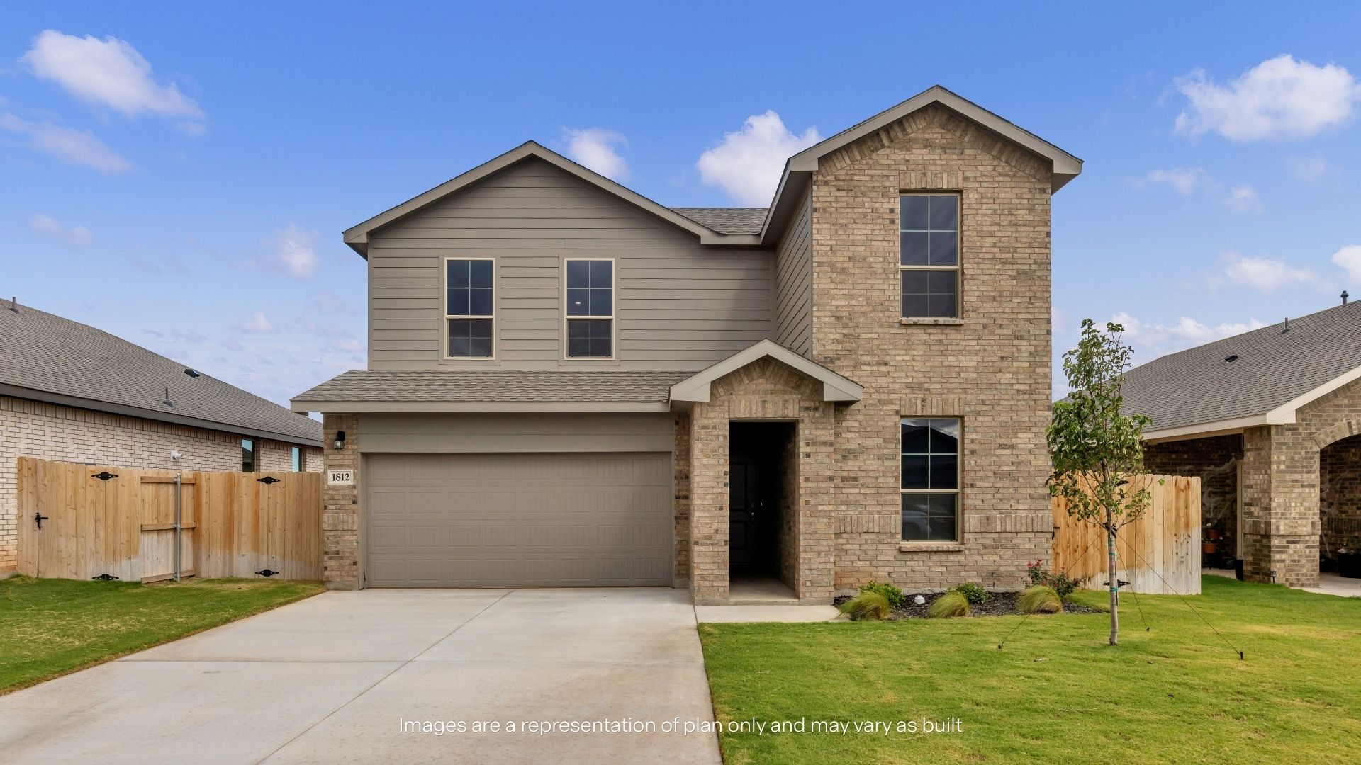 Two-story home with a brick and siding exterior, covered front entry, two-car garage, and landscaped front yard.