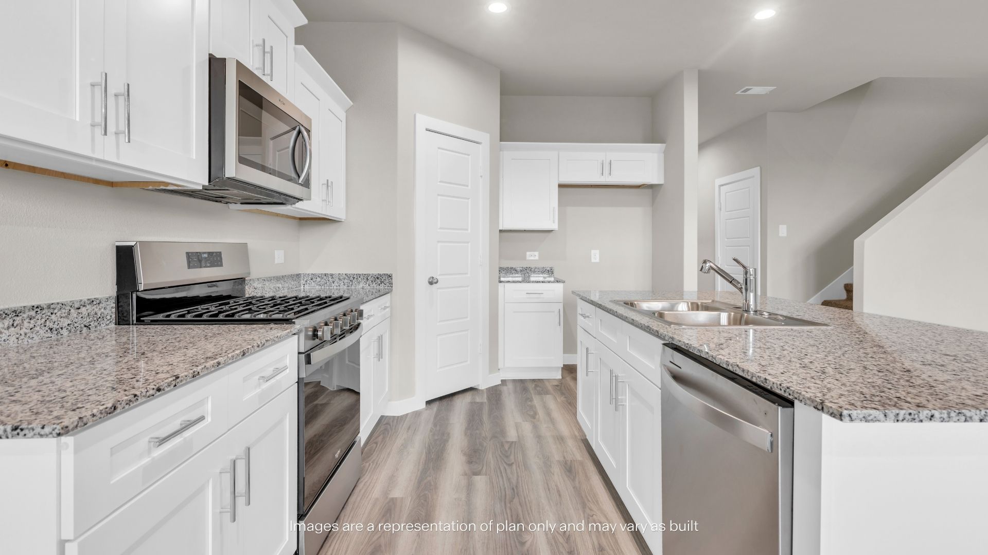 Bright kitchen showcasing granite countertops, stainless steel appliances, abundant cabinet storage, and a functional center island with sink.