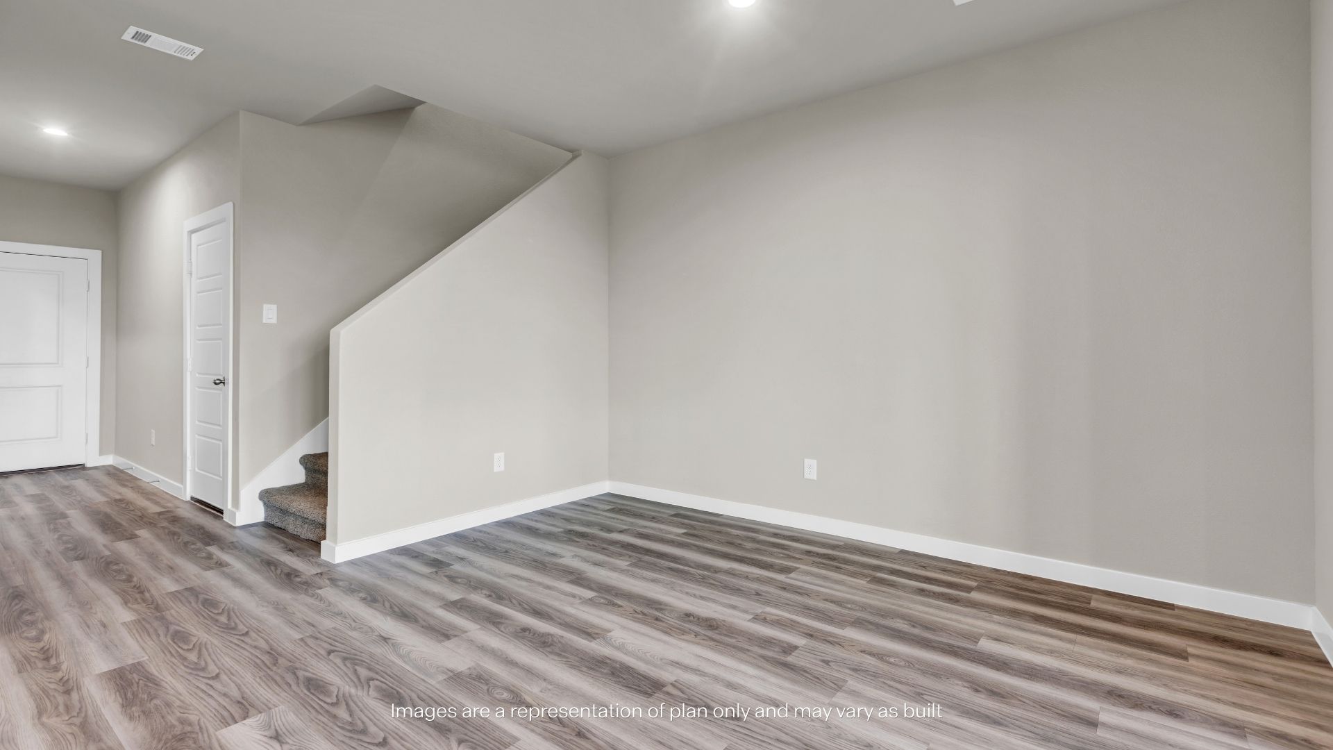 Bright and open living room with large windows, backyard access, and ample space for relaxing and entertaining.