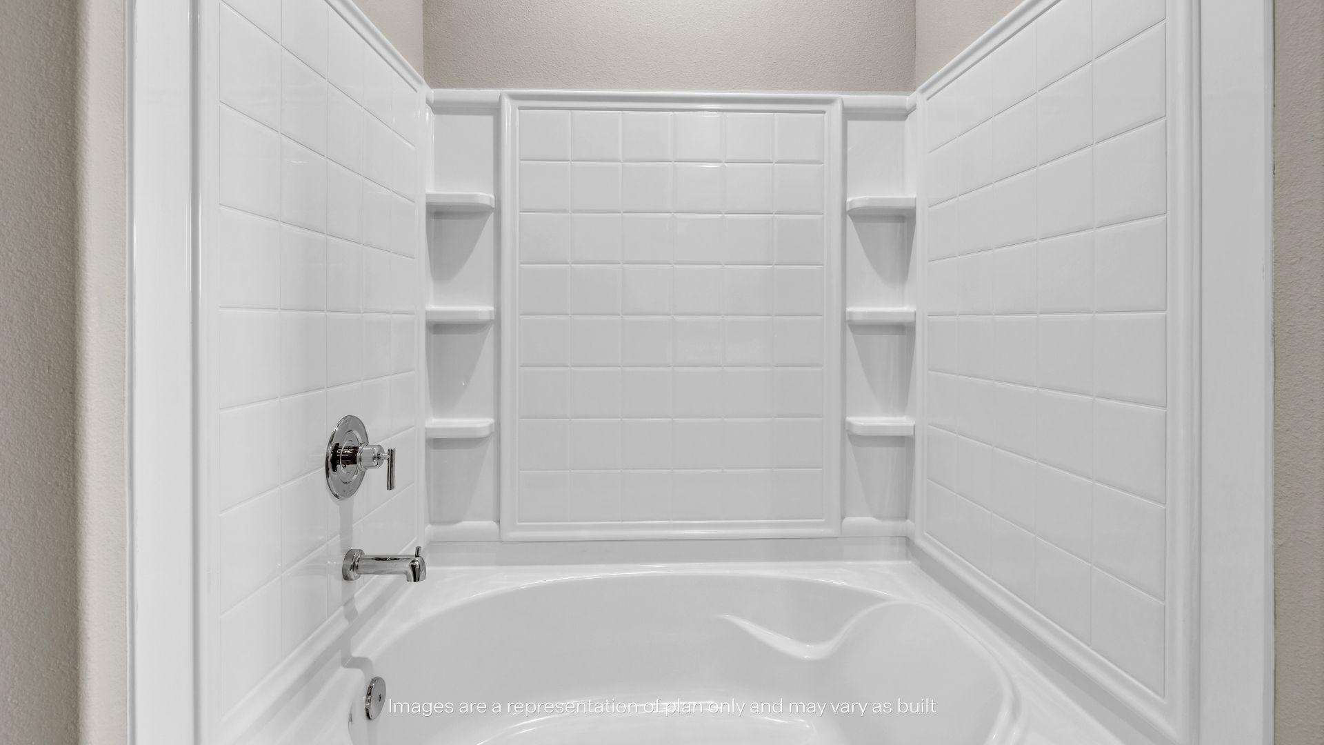 Clean tub and shower combination with built-in shelving and durable surround walls for easy maintenance.