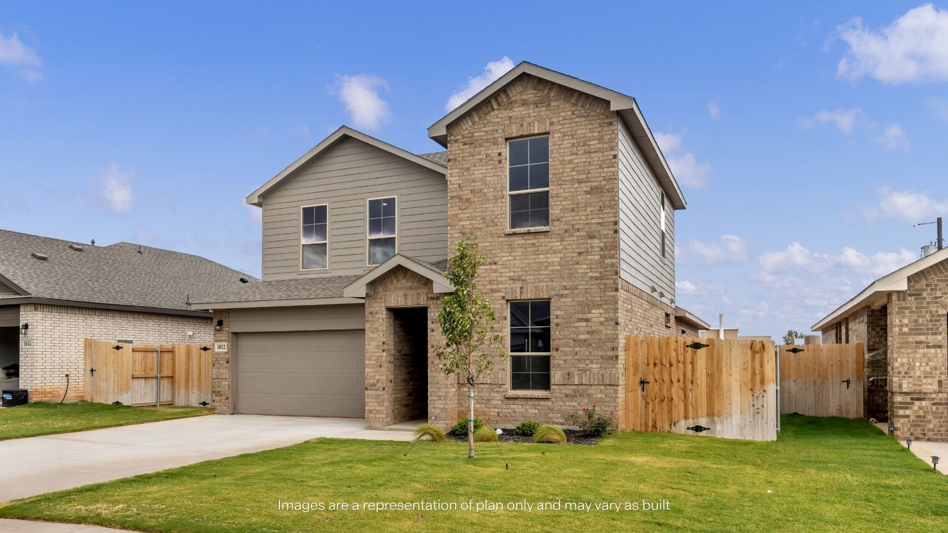 Angled view of the home's exterior highlighting the brick façade, side yard access, and manicured lawn.