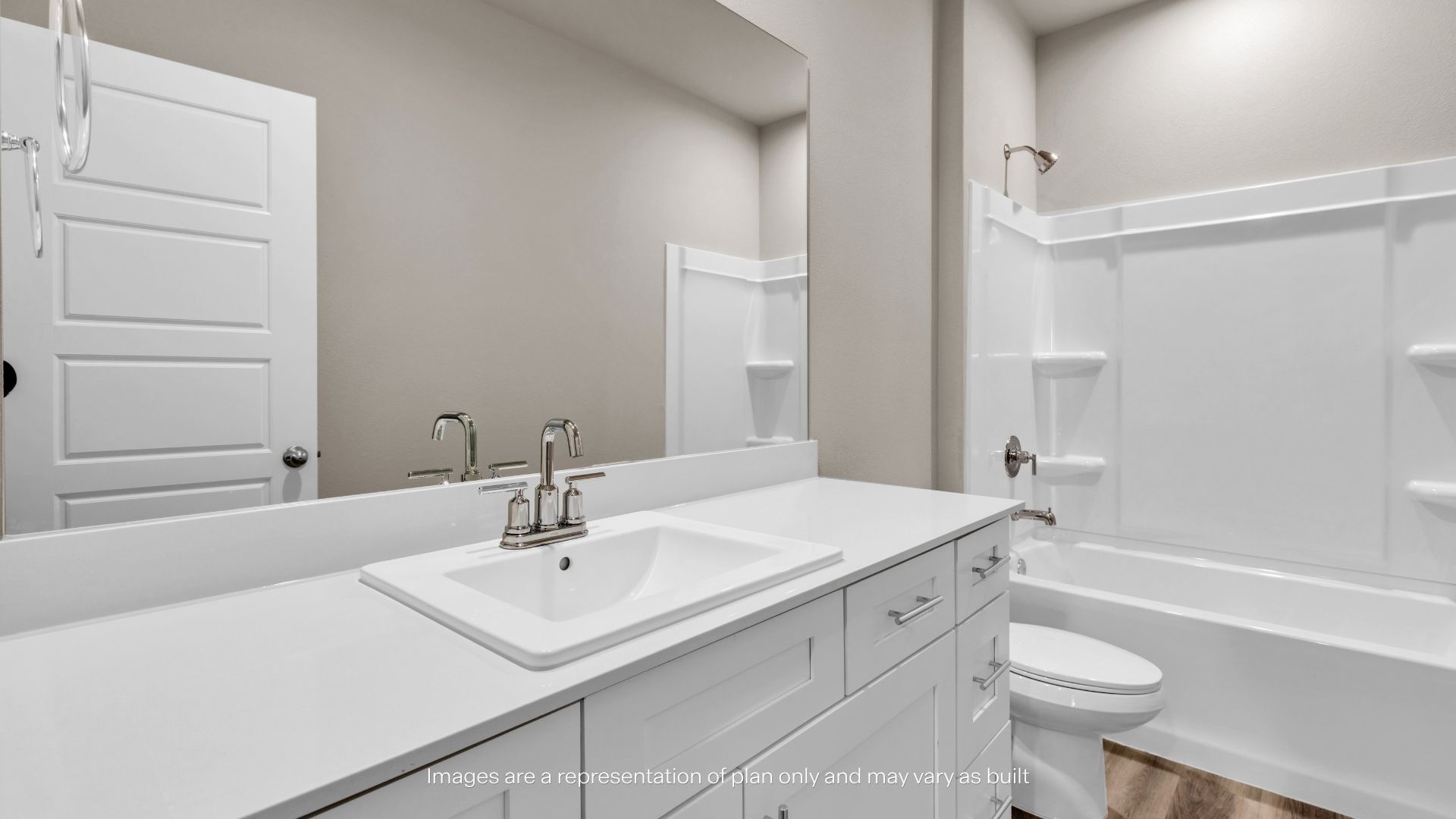 Bright bathroom featuring a single-sink vanity, large mirror, and tub/shower combination.