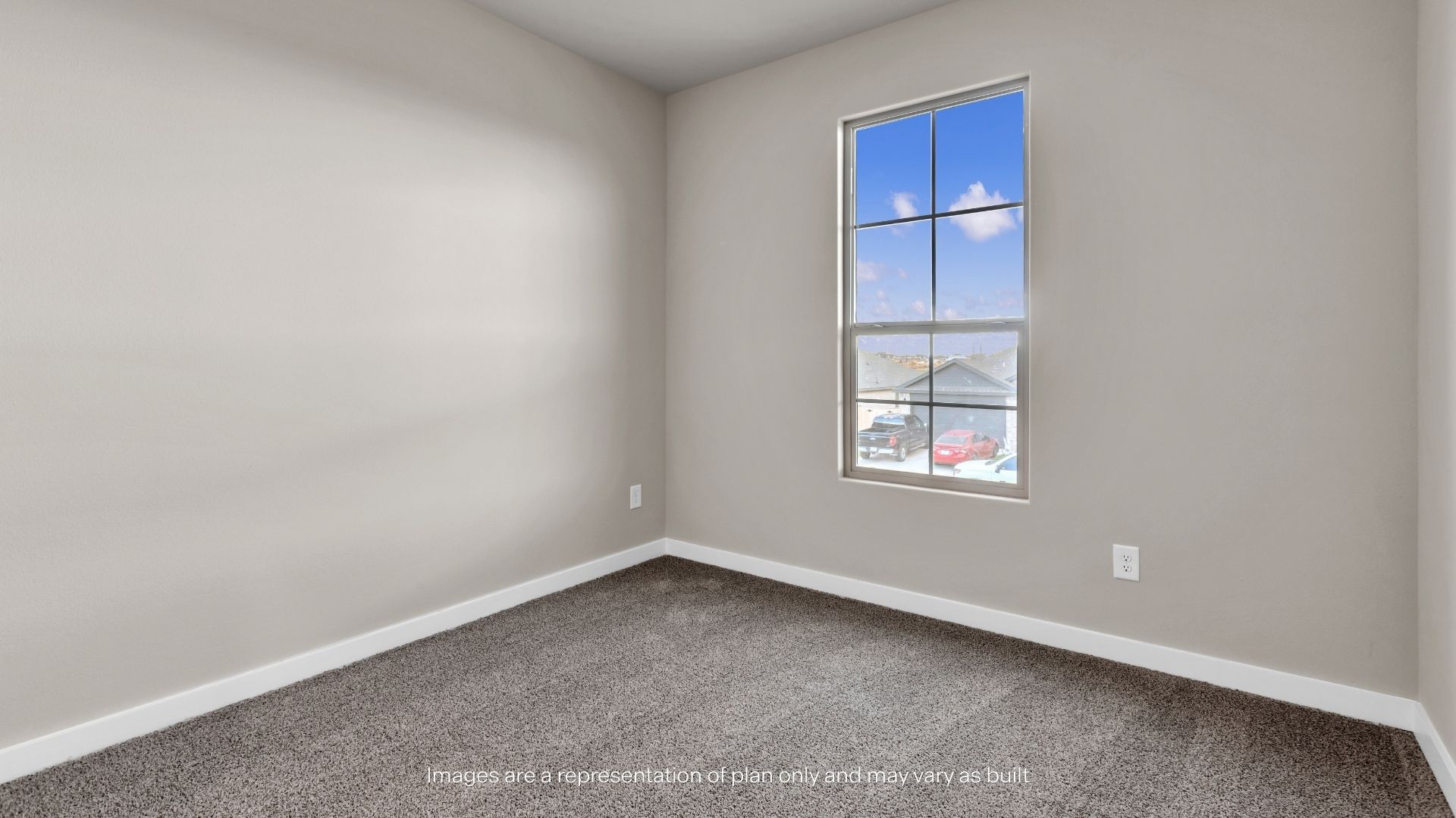 Bright secondary bedroom with neutral finishes, plush carpeting, and a functional layout for guests or family members.