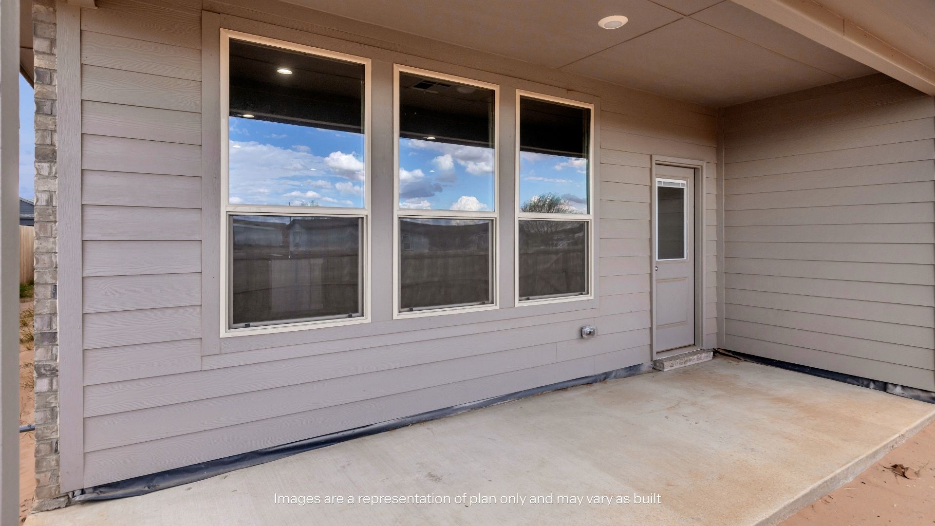 Spacious covered patio overlooking the backyard and featuring multiple windows for natural light into the home.