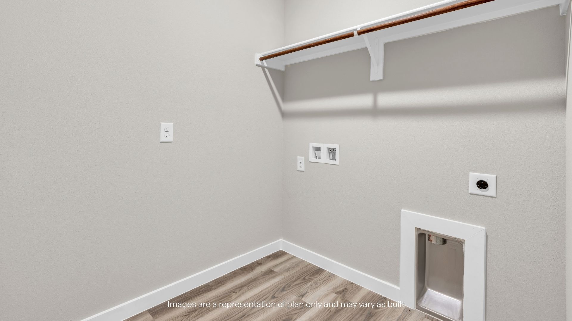 Functional laundry room with washer and dryer connections, overhead storage shelving, and durable wood-look flooring.
