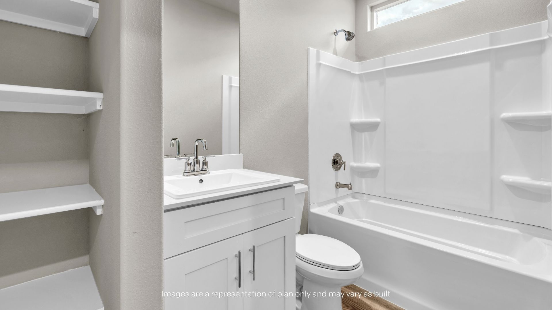 Bright secondary bathroom with a vanity, tub/shower combination, and built-in linen shelving for added storage.