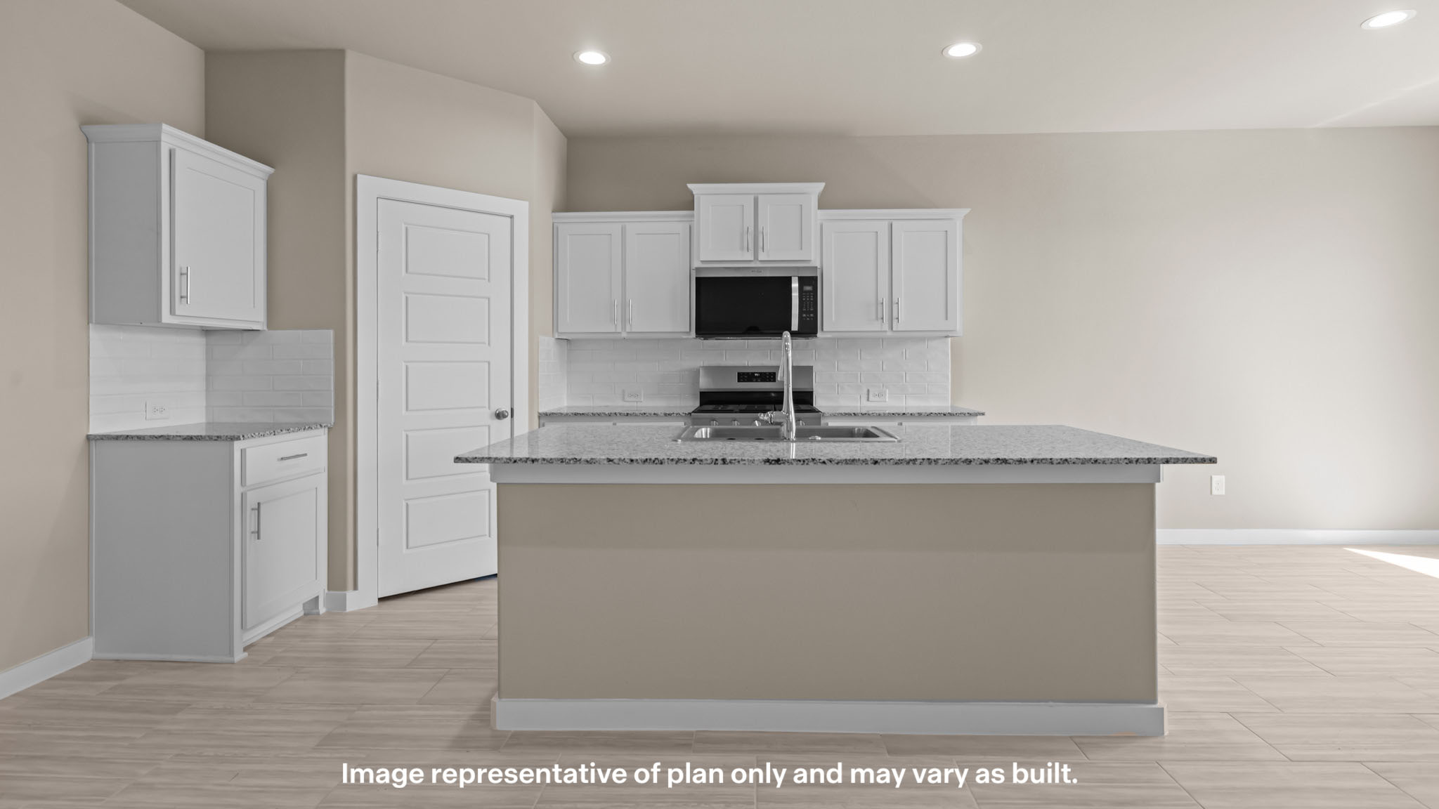 Bright kitchen featuring a large granite island.