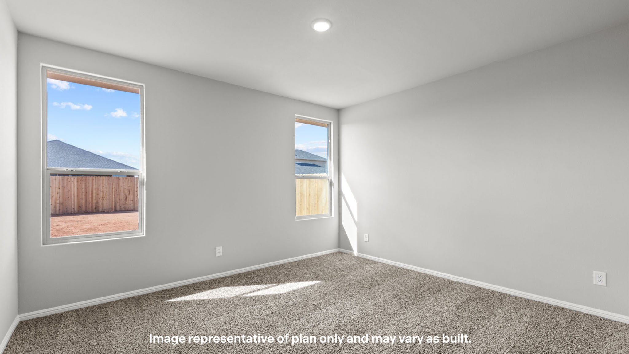 Primary bedroom with plush carpet floors and double light allowing windows